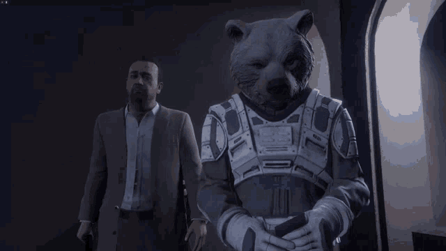 a man in a suit stands next to a bear in a suit