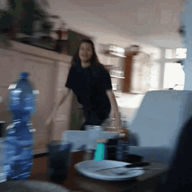 a blurry picture of a woman in a kitchen