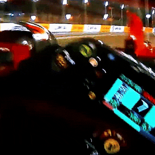 a dashboard of a race car with a green screen that says ' a ' on it