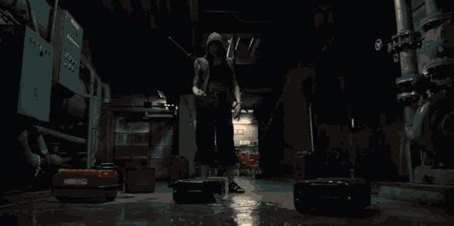 a woman in a hooded jacket is standing in a room with a fire circle around her