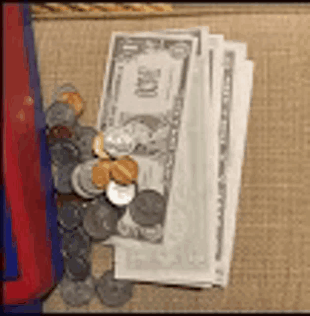 a pile of coins and a stack of money on a table