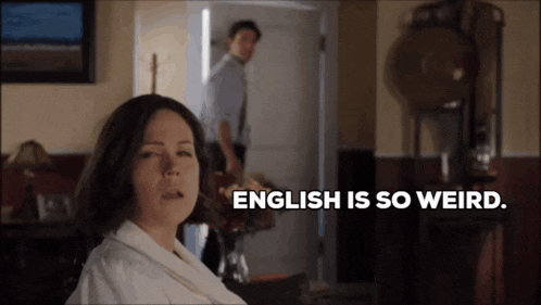 a woman says english is so weird in front of a man in a doorway