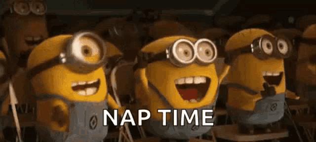 a group of minions wearing goggles are standing next to each other in a classroom and laughing .