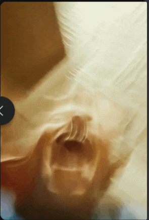 a close up of a person 's face with a black x on the bottom right
