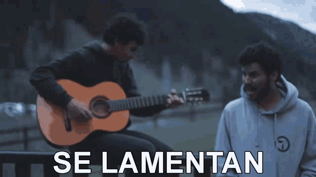 a man playing a guitar next to another man with the words se lamentan written on the bottom