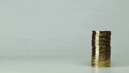 several stacks of gold coins are lined up in a row on a table