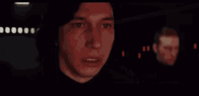 a close up of a person 's hand holding a gun in a dark room