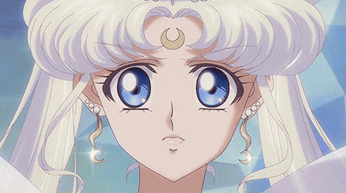 a close up of a girl with a crescent moon on her head