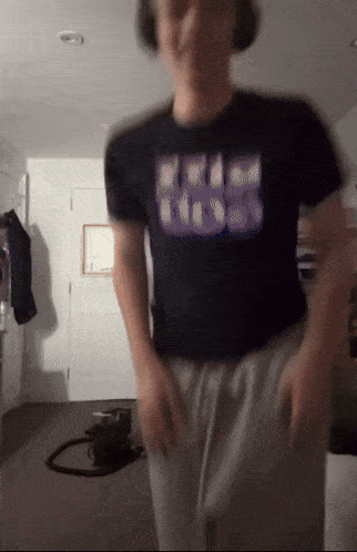 a blurry picture of a person wearing a black shirt that says ' free hugs '