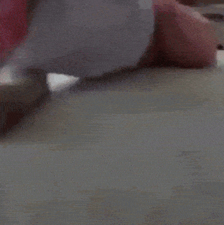a person is laying on a bed with their legs crossed .