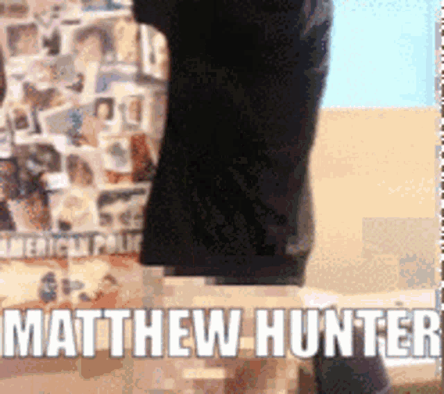 matthew hunter is standing in front of a wall