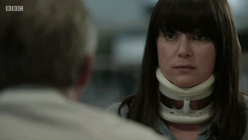 a woman with a brace around her neck is talking to a man with the bbc logo on the bottom
