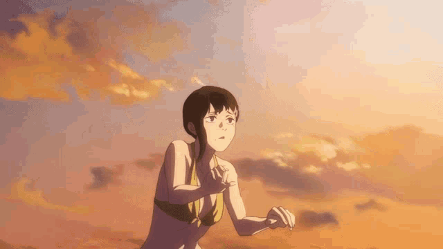 a girl in a bikini is running on a beach at sunset