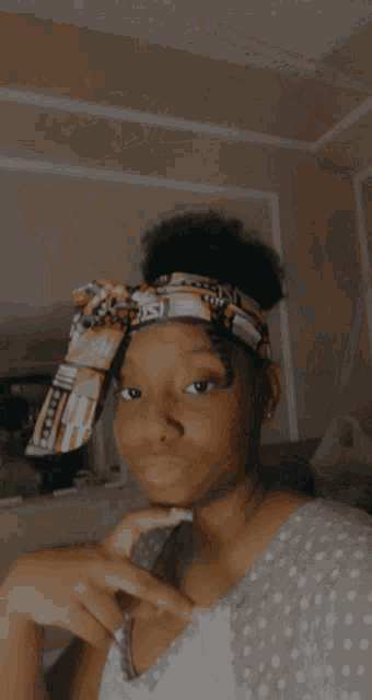 a woman wearing a headband with the letter s on it