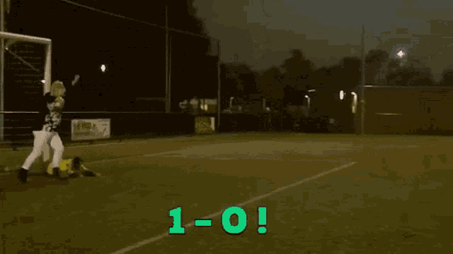 a soccer game is underway with the score 1-0