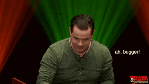 a man in a green shirt says ah bugger in front of a green light