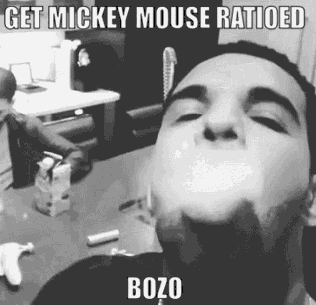 a man is smoking a cigarette with the caption get mickey mouse ratioed bozo