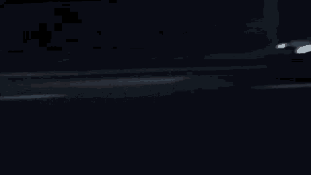 a car is driving down a highway at night with a license plate that says ' 300 ' on it