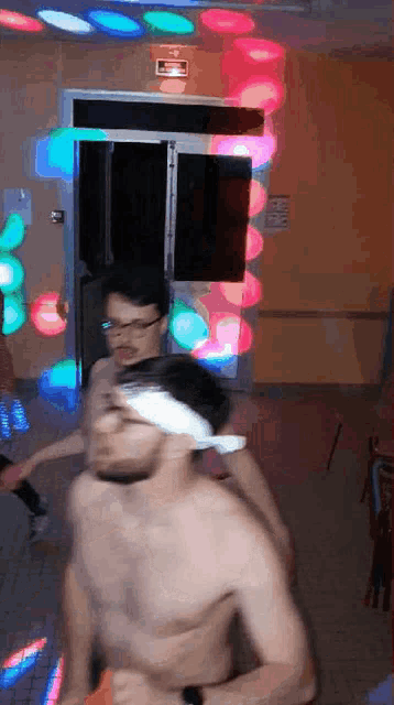 a shirtless man with a bandage on his head is dancing