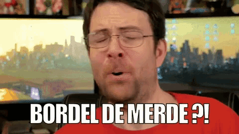 a man with glasses and a red shirt says bordel de merde ?