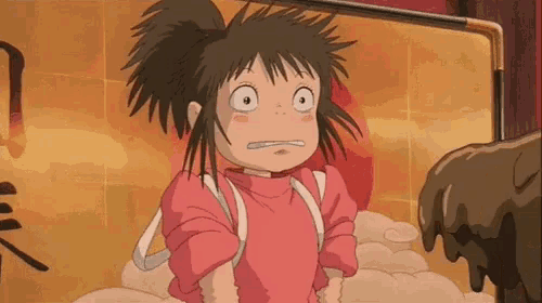a girl from spirited away is making a funny face while standing in front of a wall .