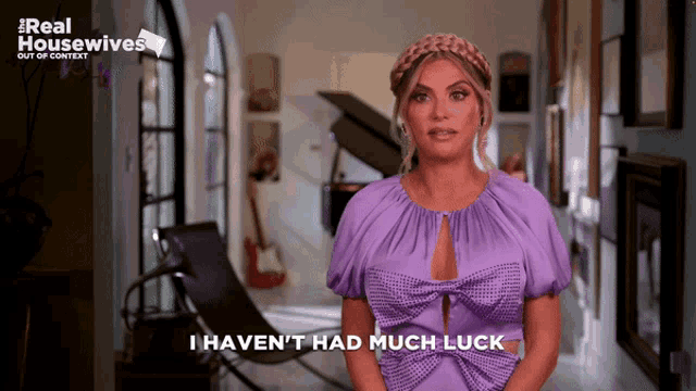a woman in a purple dress with the words i haven t had much luck