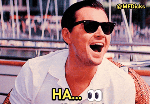 a man wearing sunglasses and a white shirt is laughing and says ha