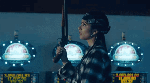 a woman in a bandana holds a gun in front of a slot machine that has a winning amount of $ 1,850