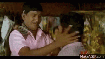 a couple of men are hugging each other in a room .