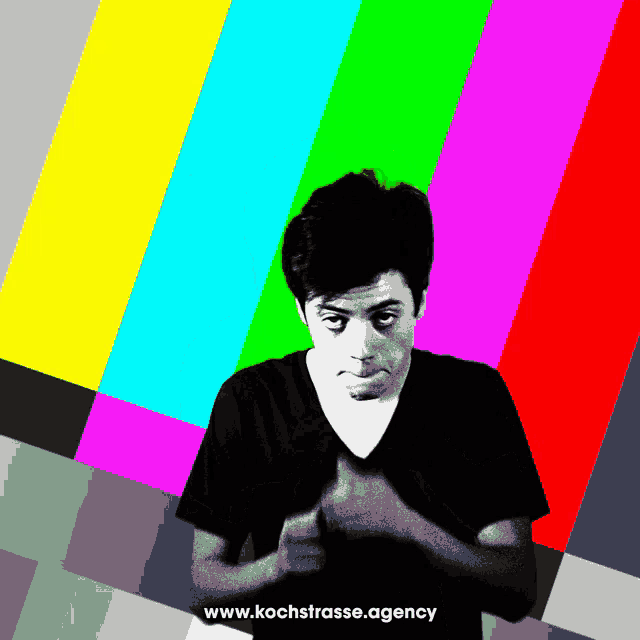 a man is standing in front of a colorful background with the website www.kochstrasse.agency written below him
