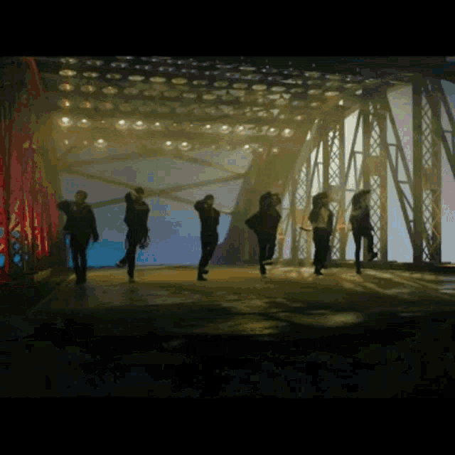 a group of people are dancing on a stage