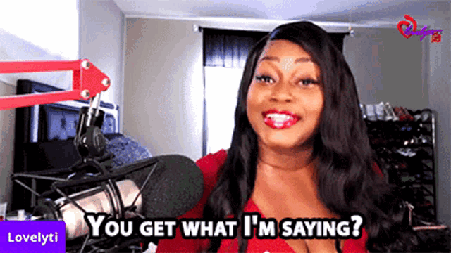 a woman standing in front of a microphone with the words you get what i 'm saying