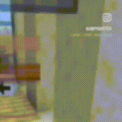 a pixelated image of a person standing in front of a locker .