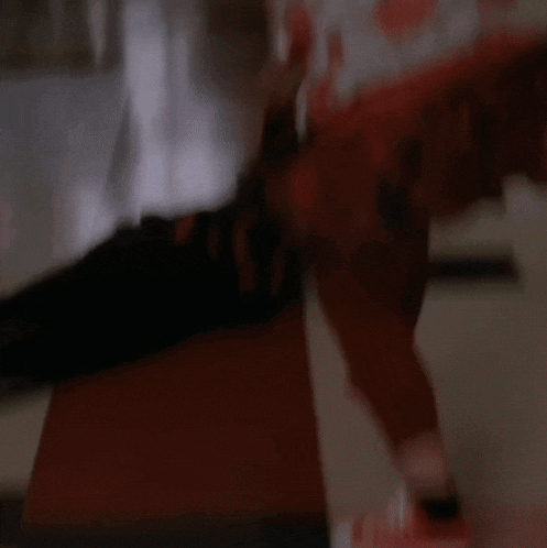 a person in a floral shirt is laying on the floor in front of a stop sign