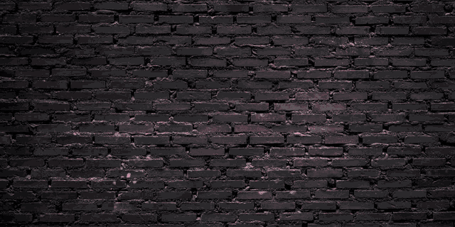 a neon sign that says glow on a black brick wall