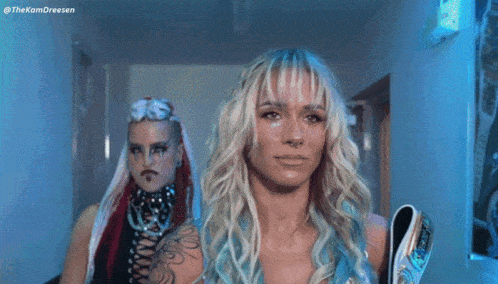 two women are standing next to each other with the hashtag thekomdreesen on the bottom left