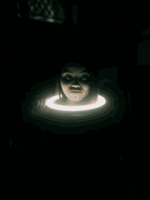 a woman is holding a light ring around her head
