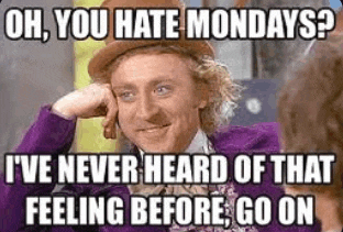a man in a purple suit and hat is talking to another man in a purple suit .