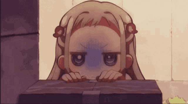 a cartoon girl is peeking out from behind a wooden box .