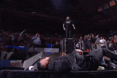 a man in a suit is being thrown in the air by another man in a suit .
