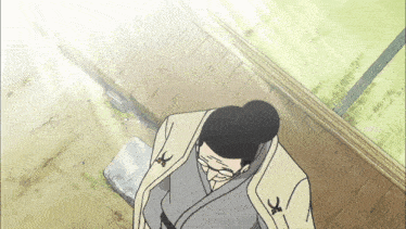 a cartoon of a man wearing glasses and a kimono with the letter k on the sleeve