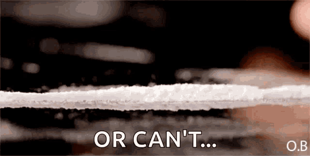 a close up of a person taking a line of cocaine with the words or can 't written on the bottom