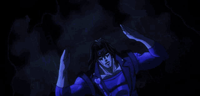 a man in a blue suit is standing in a dark room with his hands in the air