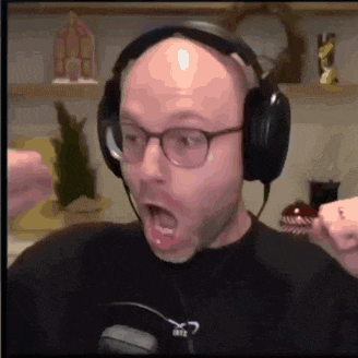 a bald man wearing headphones and glasses is making a funny face