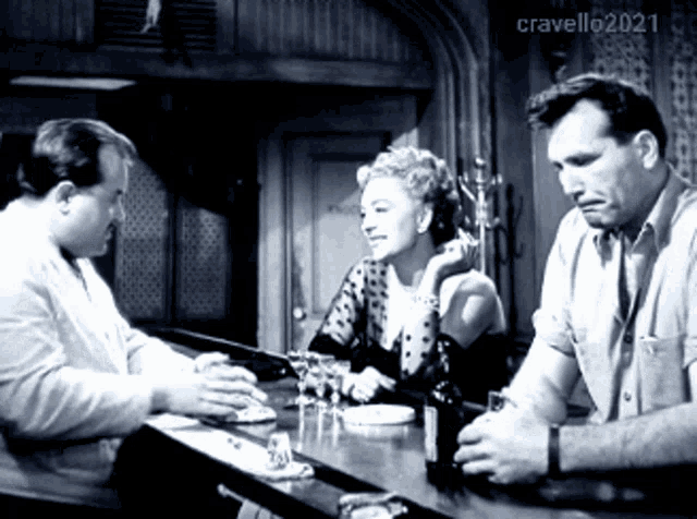 a black and white photo of people at a bar with the year 2021