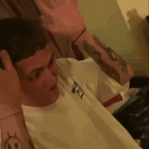 a man with a tattoo on his arm that says ' a ' on it