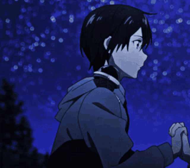 a person wearing headphones stands in front of a blue sky