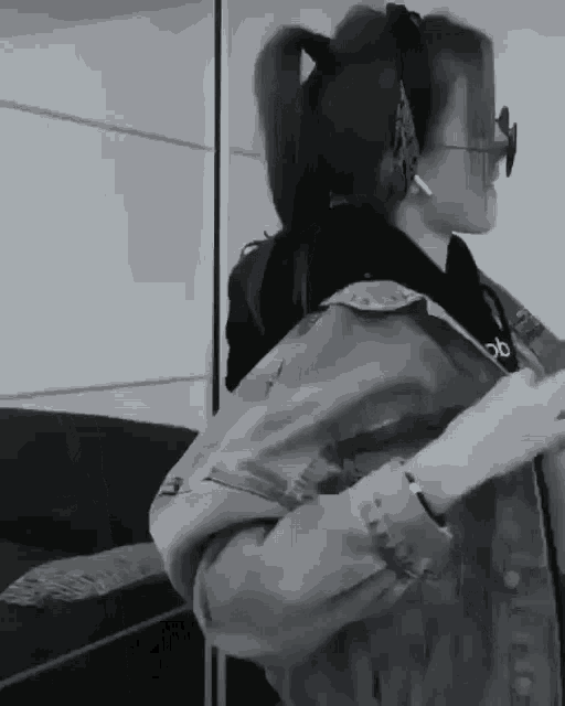 a black and white photo of a girl wearing headphones