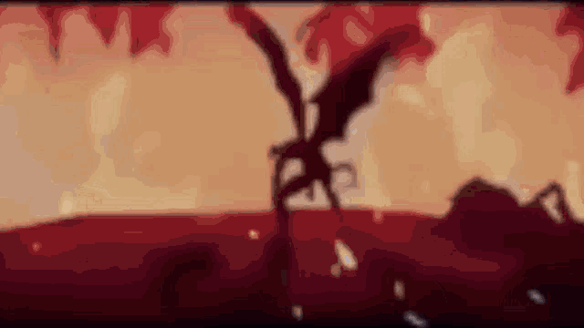 a silhouette of a dragon with wings flying in the air against a red background .