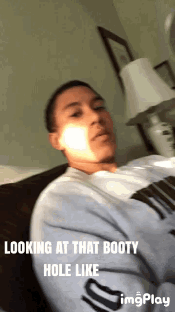 a man is laying on a bed with the caption looking at that booty hole like ..
